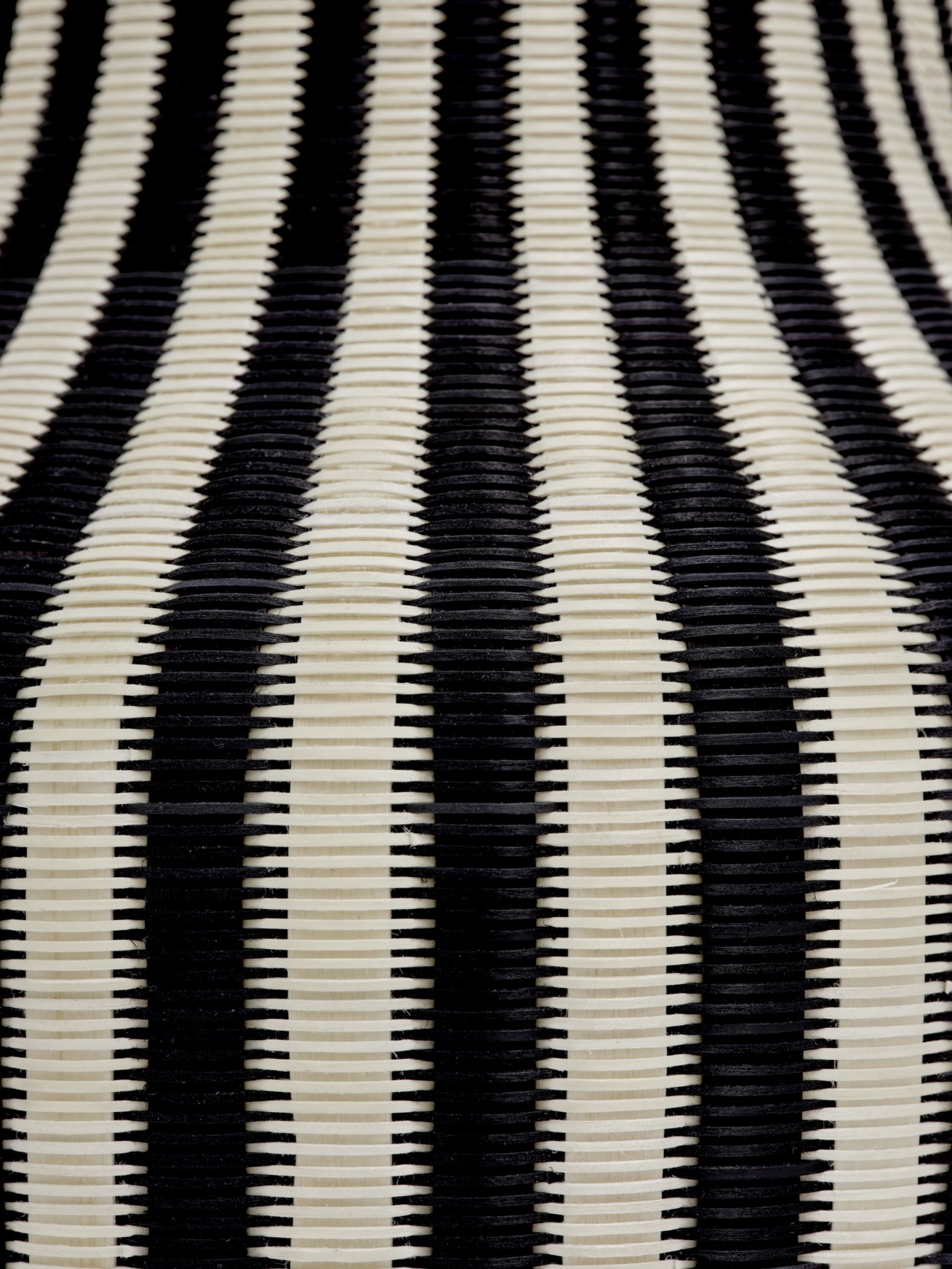 A close-up of a beige and white striped basket.