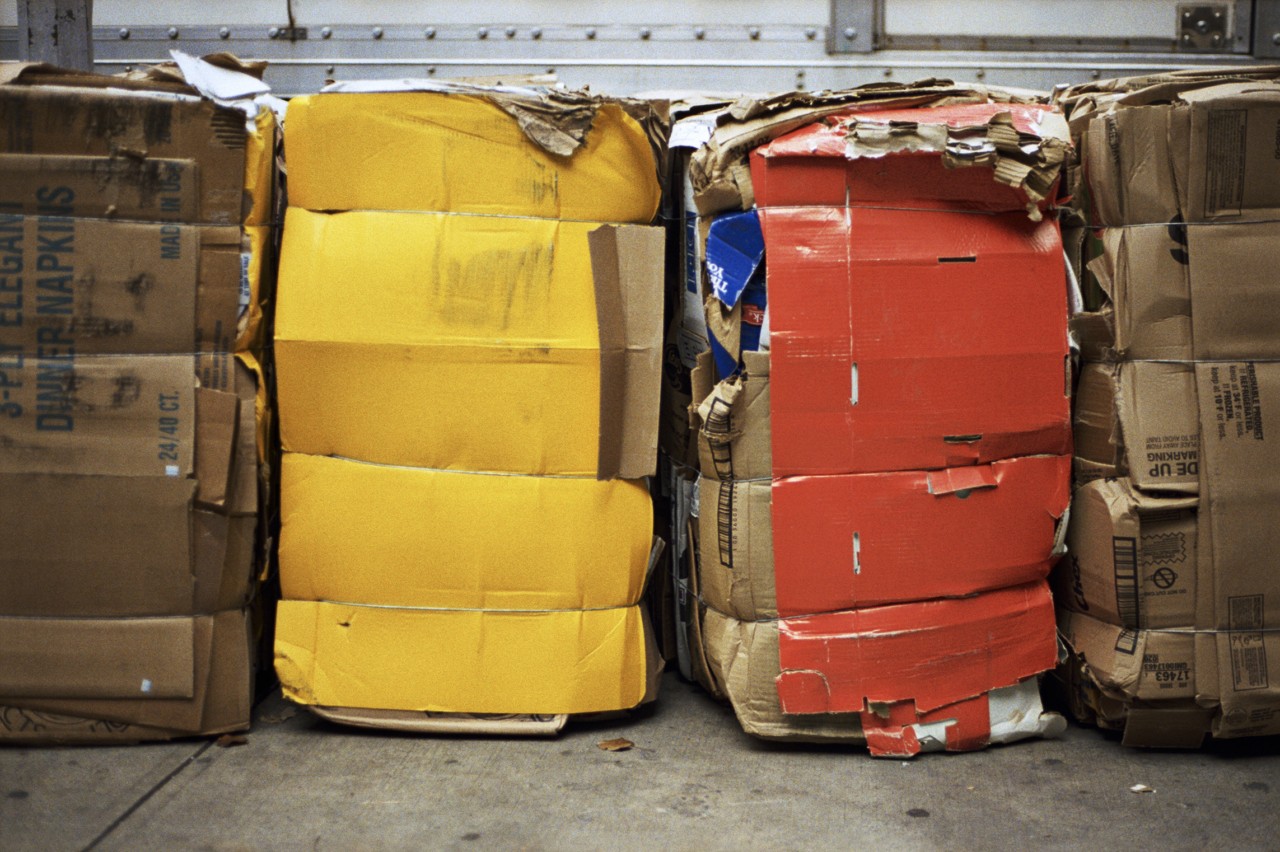 Paper and plastic waste boxes sit in a storage unit.
