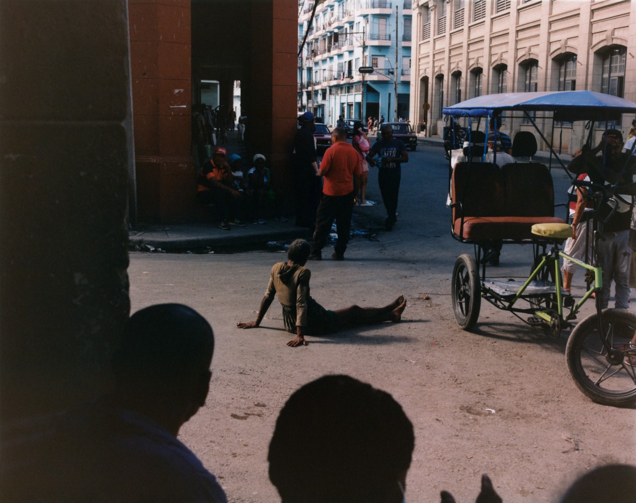 Several people mingle in a downtown area of Cuba.