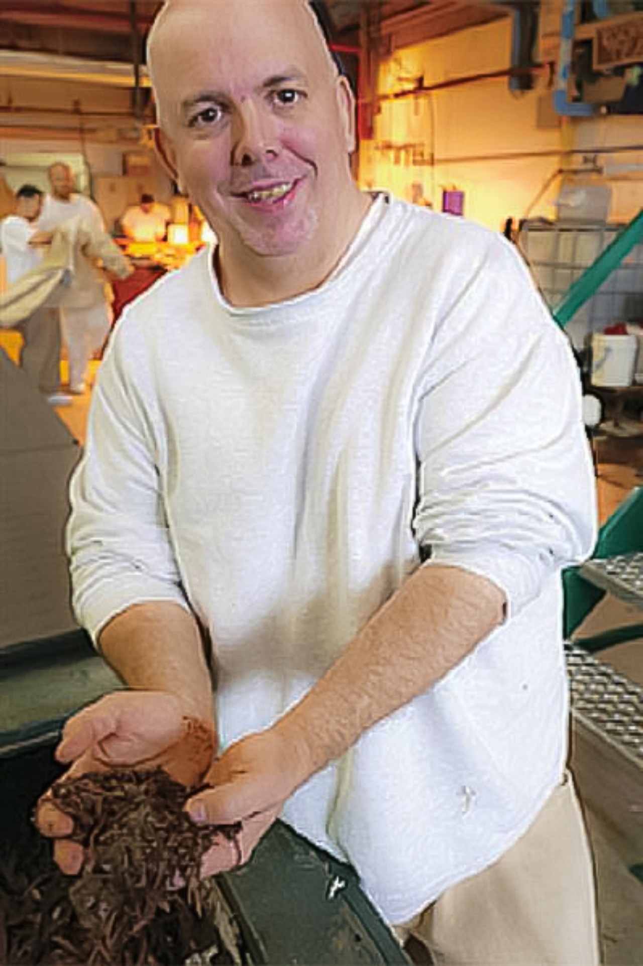 Nick Hacheny holding soil in his hands.
