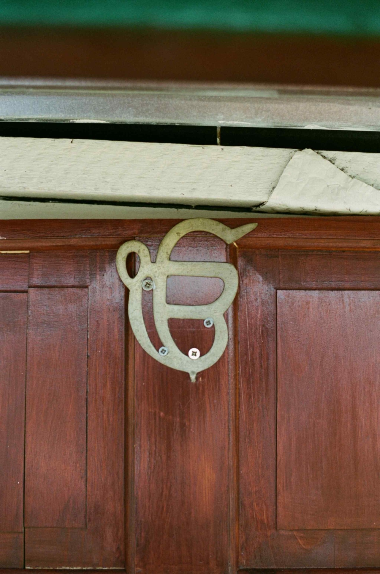 A symbol carved into a wooden door.