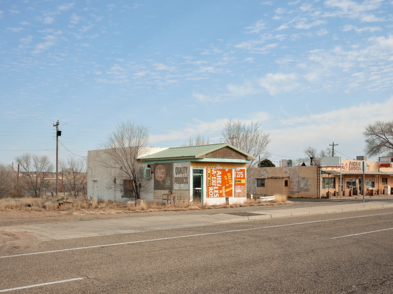 A barren building sits along a road in a ghost town along Route 66.