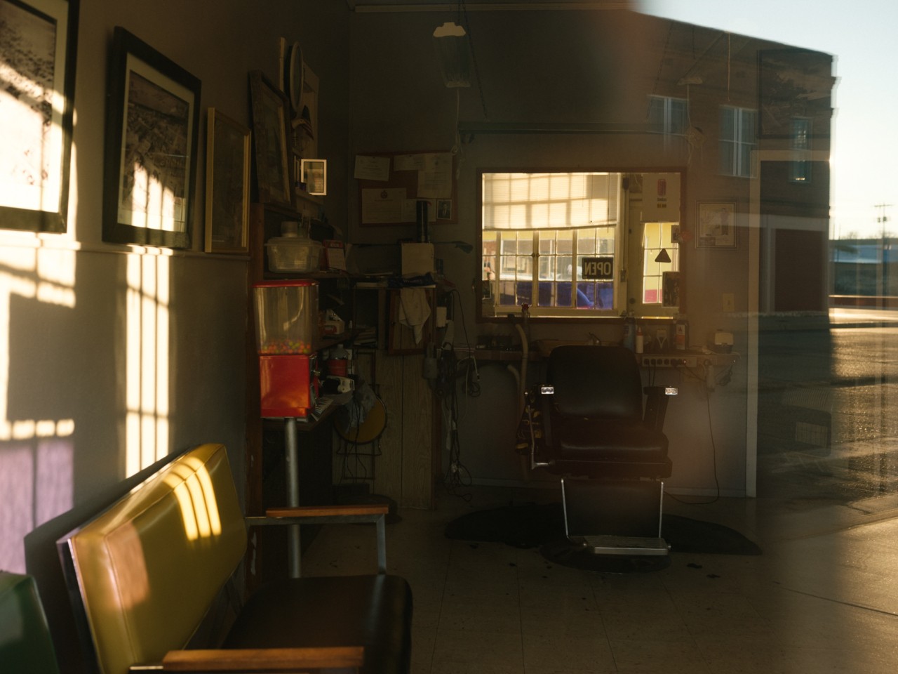 The inside of an empty room reveals a couch and chair.