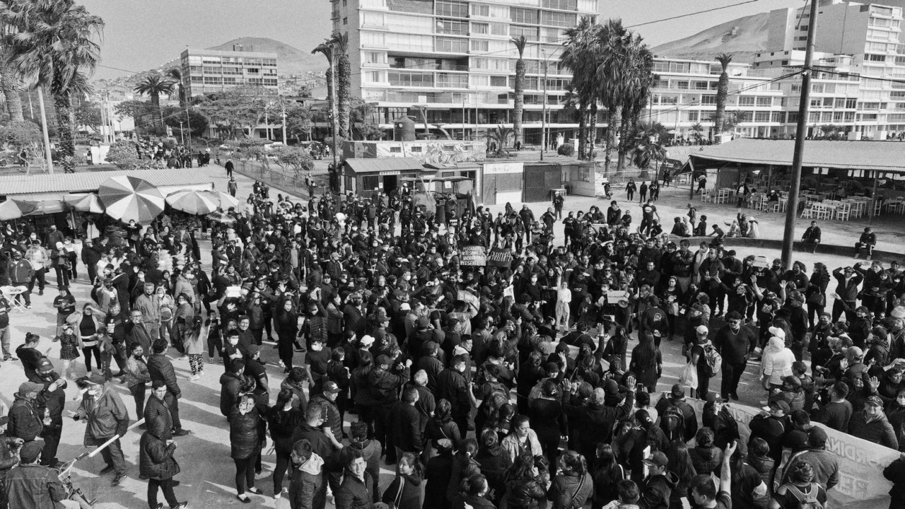 A large group of people gather to protest the oil company that caused a massive oil spill in the waters of Peru.