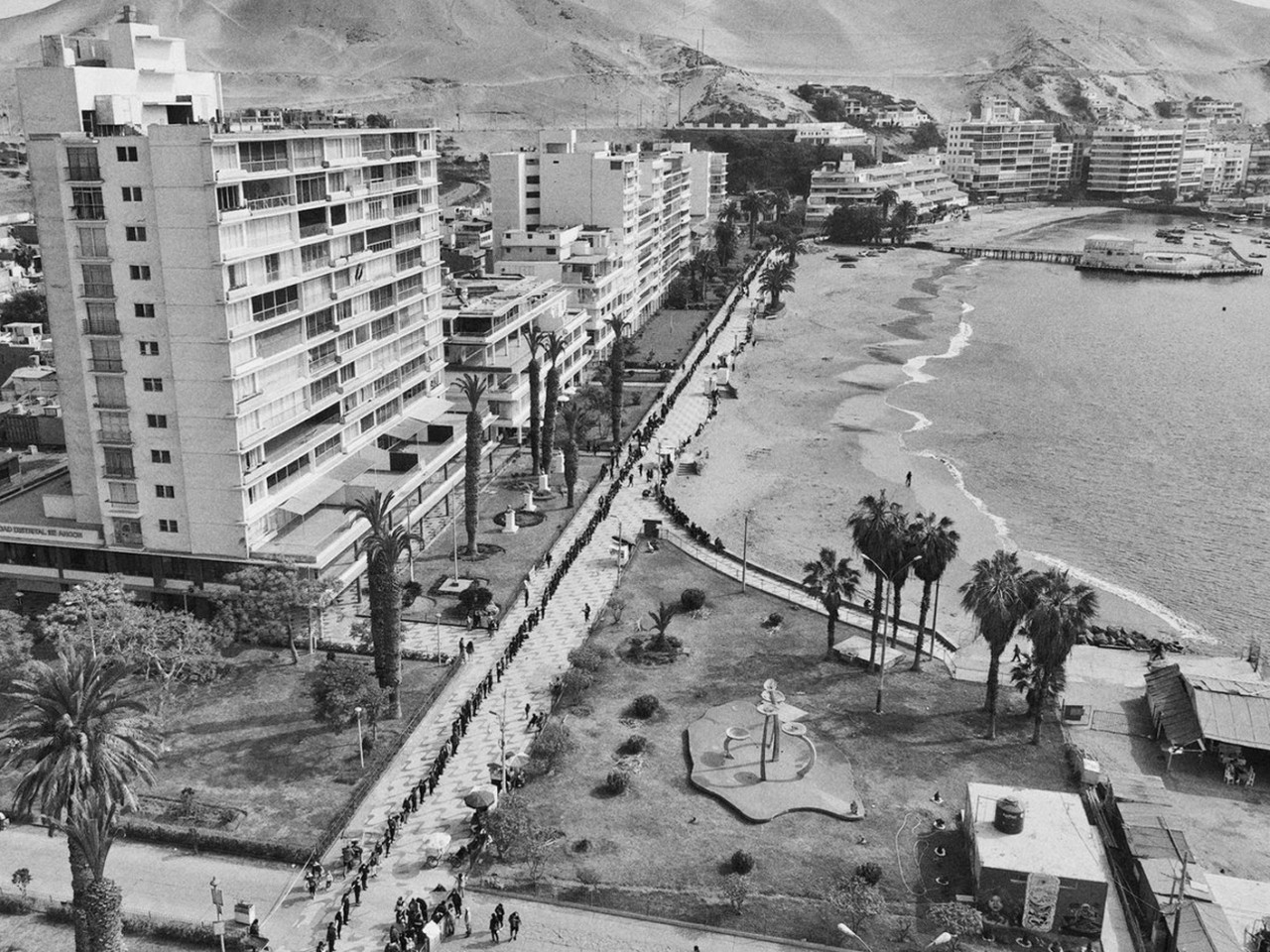 An above shot of the shoreline where a string of buildings meets the ocean in Peru that had a massive amount of oil spilled into it.