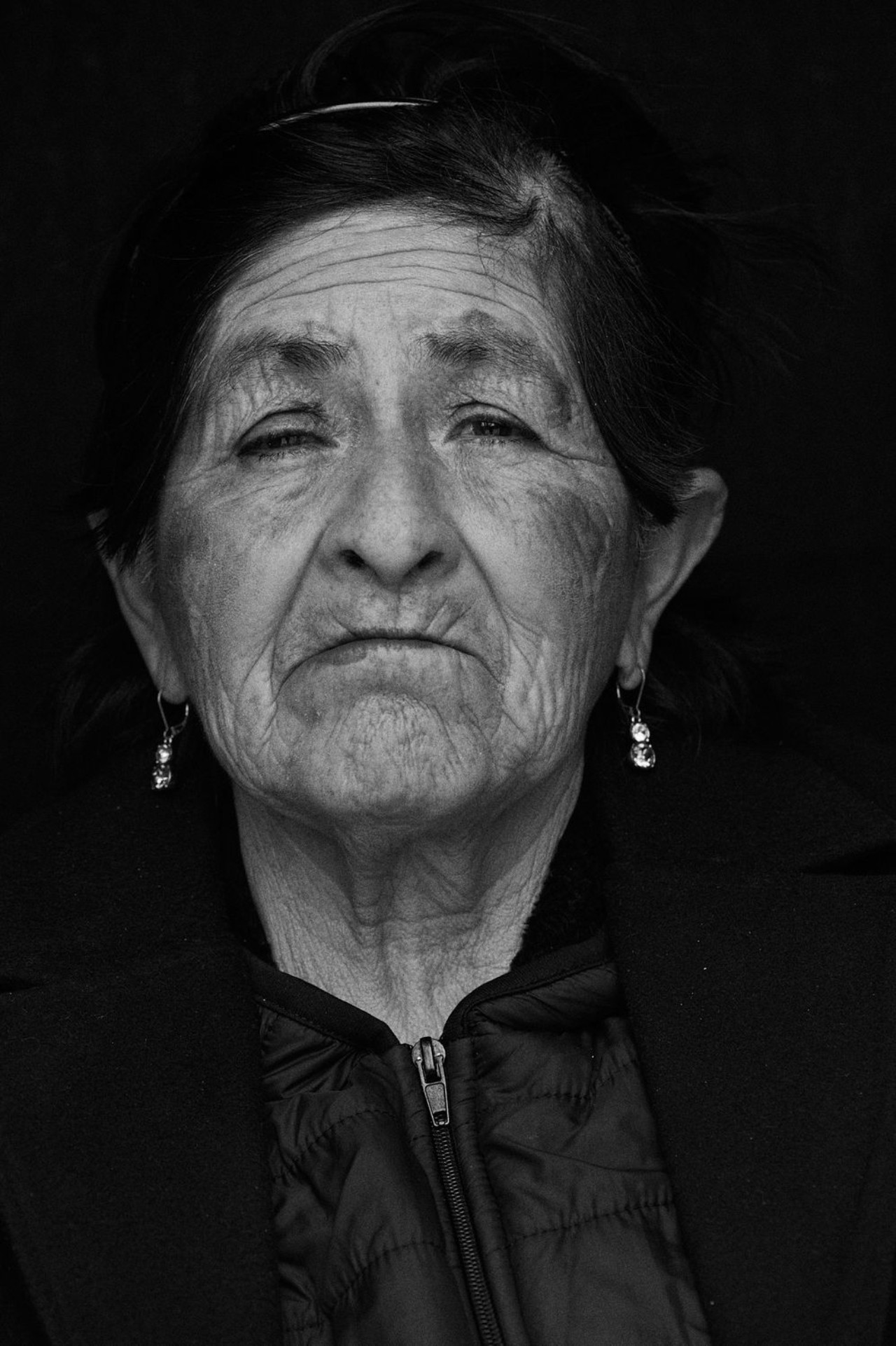 A portrait of an older Peruvian woman.