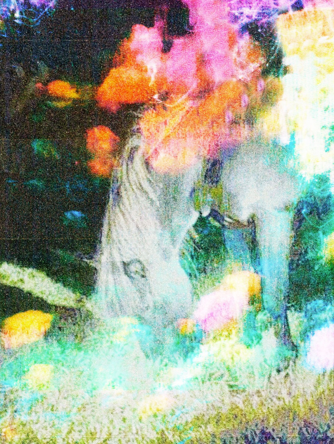 A horse surrounded by bright abstract colors bends down to eat some grass.