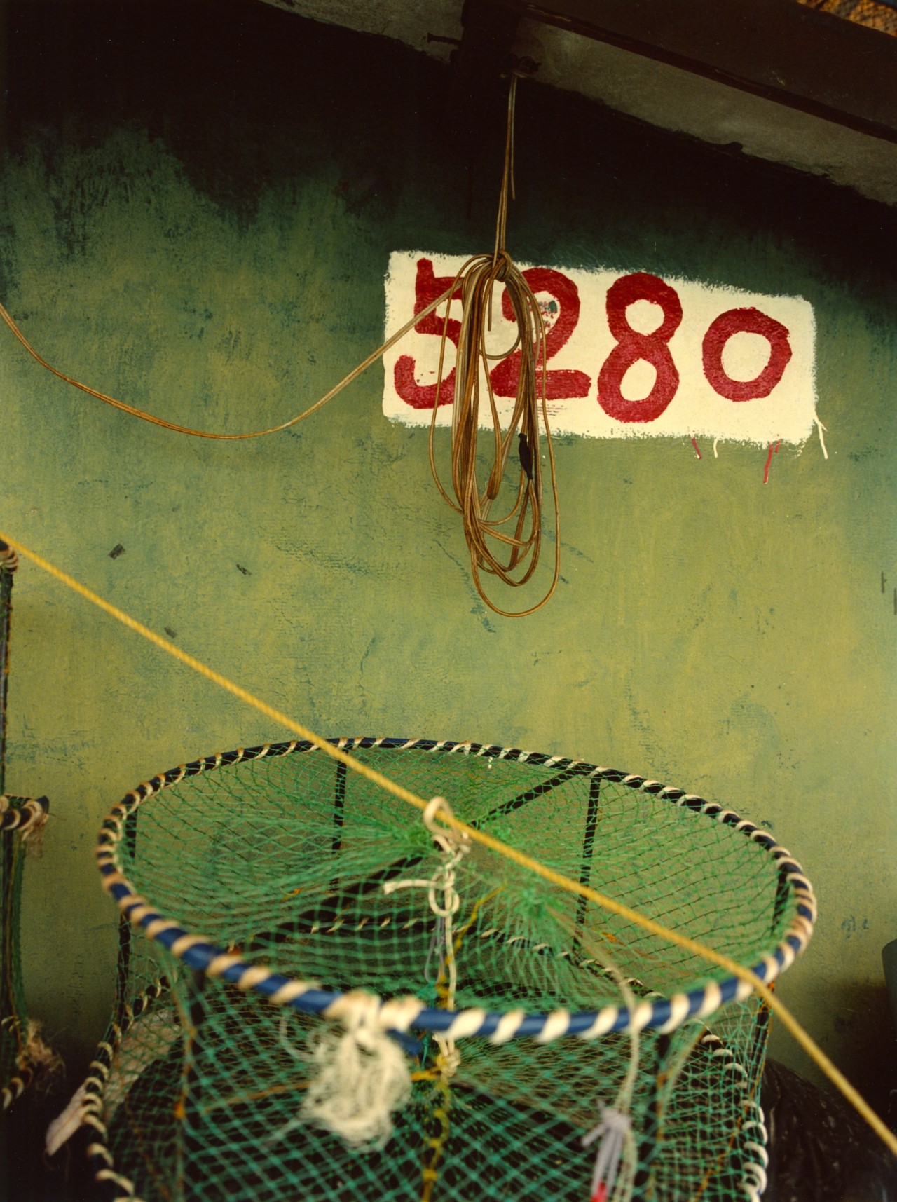 The numbers 5280 are painted on a green wall.