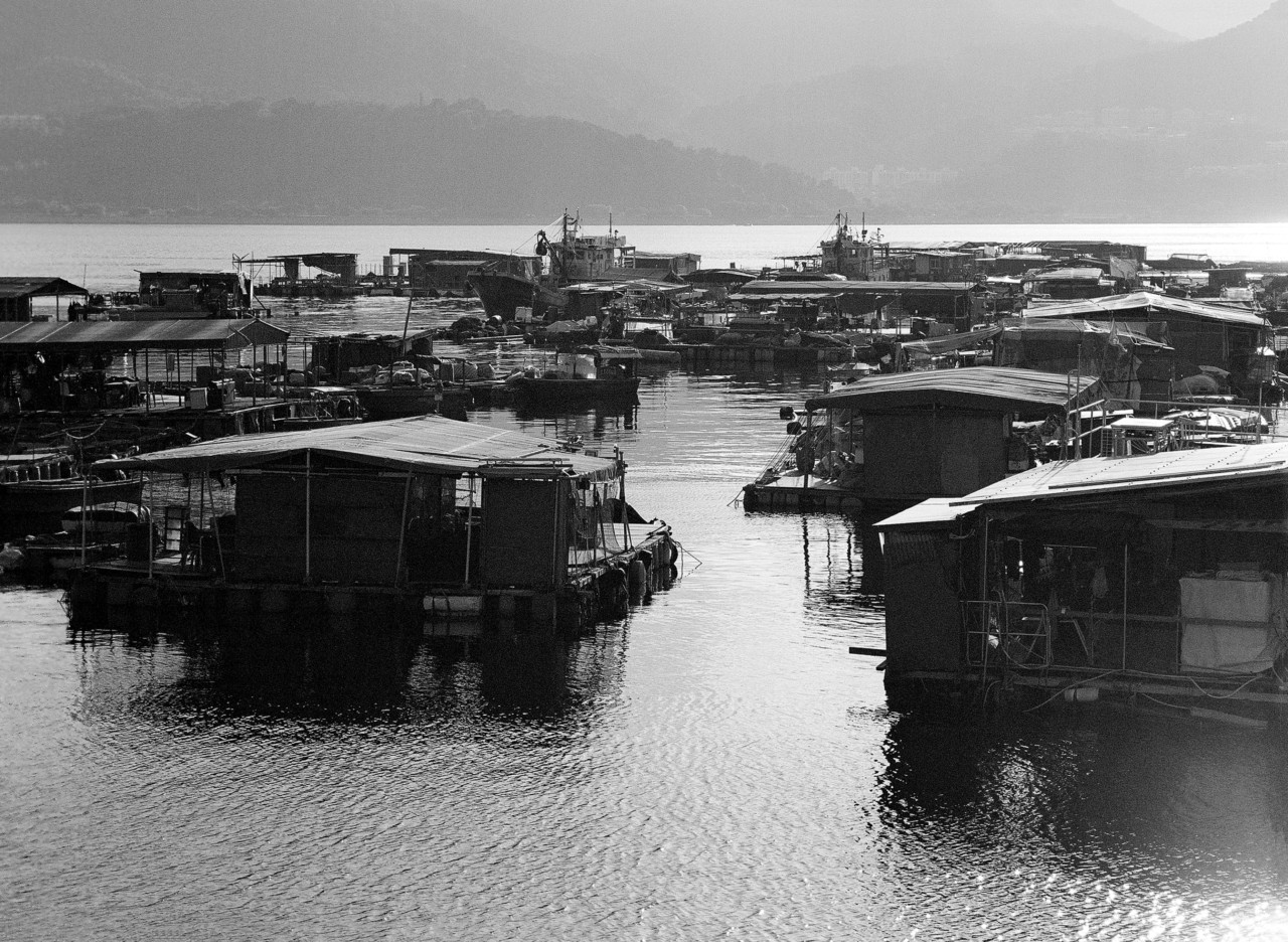 Several houses sit on the water in Hong Kong.
