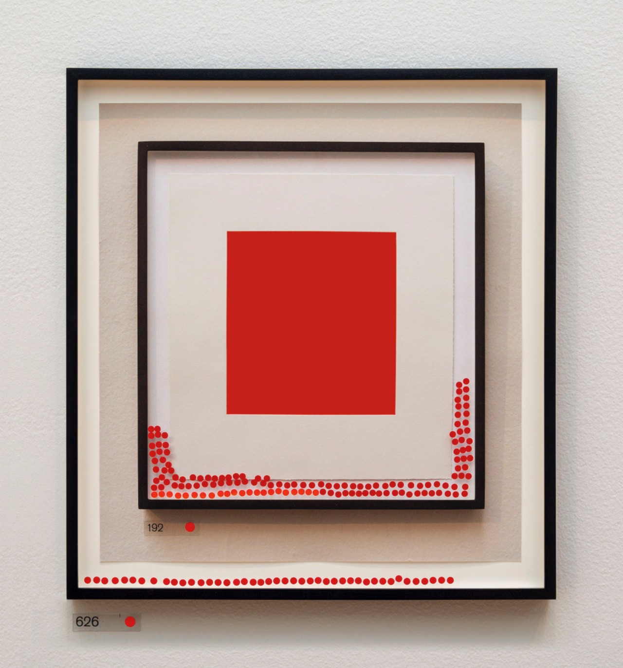 A piece of art depicting 4 concentric squares, the smallest of which is red.