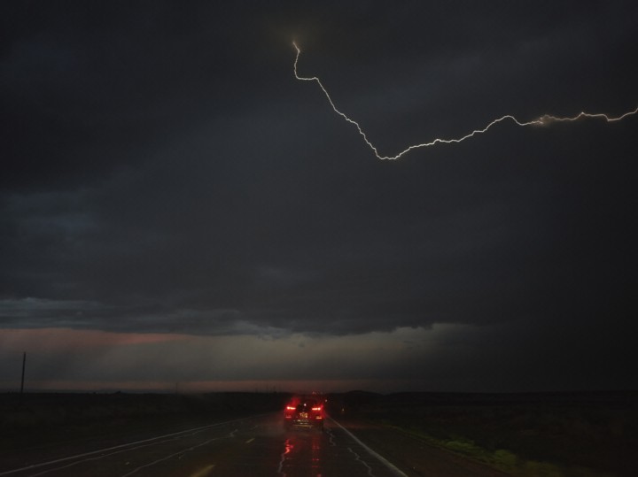 Lighting strikes as a car drives to Tucumcari, NM from Dalhart, TX