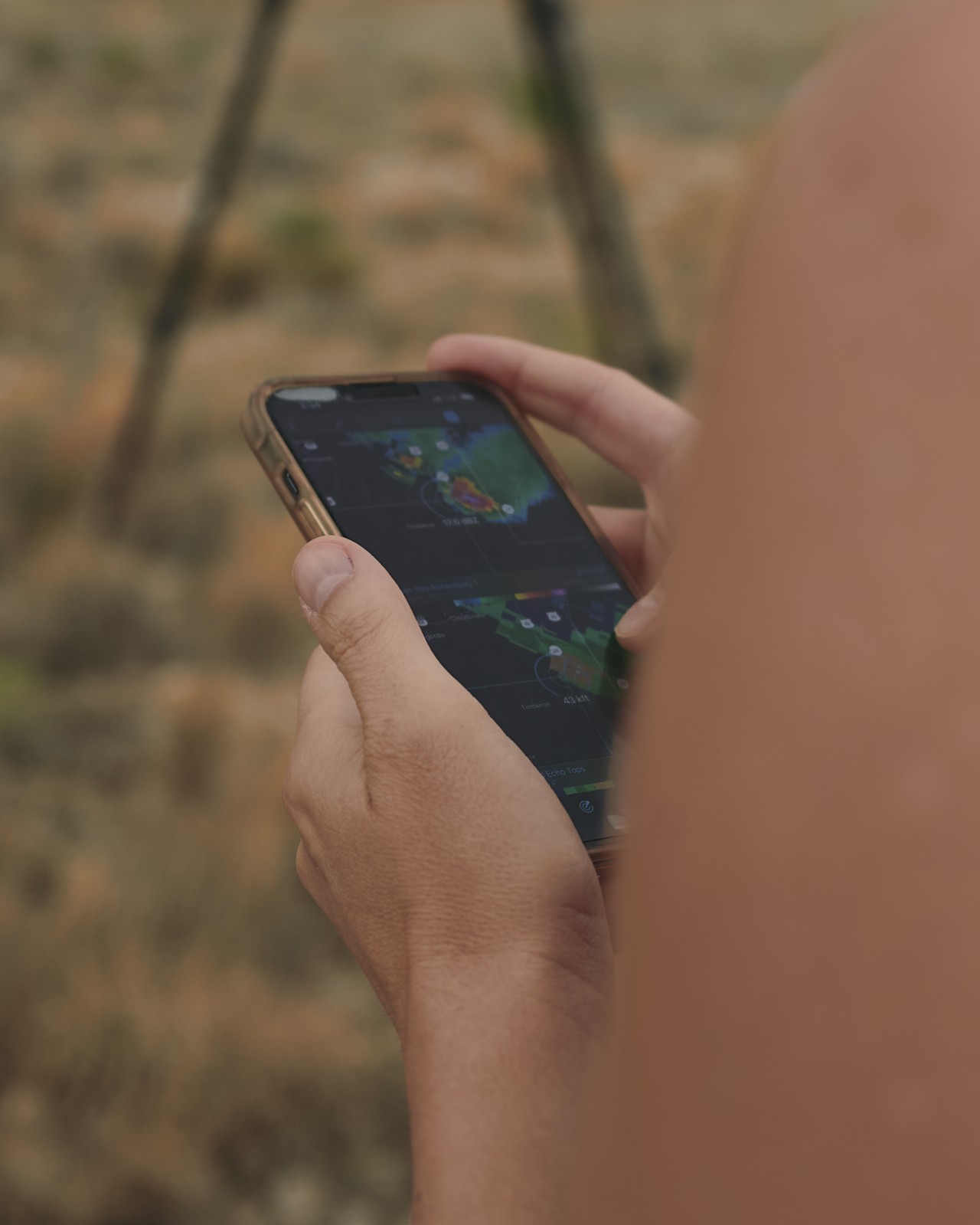 Raychel Sanner checks her radar app in Hope, NM