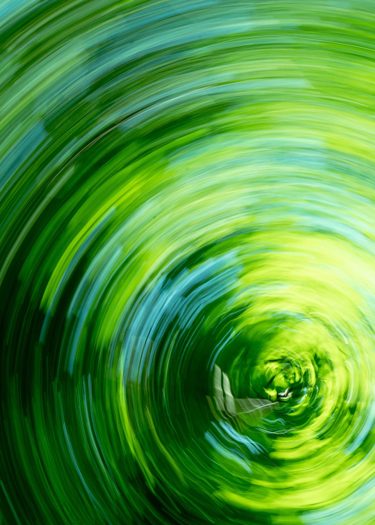 Bright green and blue colors swirl around in a circle.