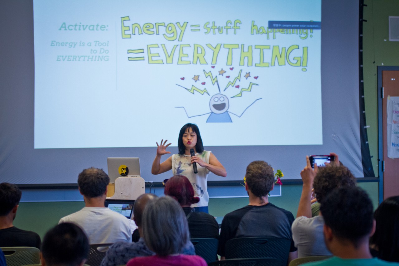 An activist artist gives a presentation on energy.