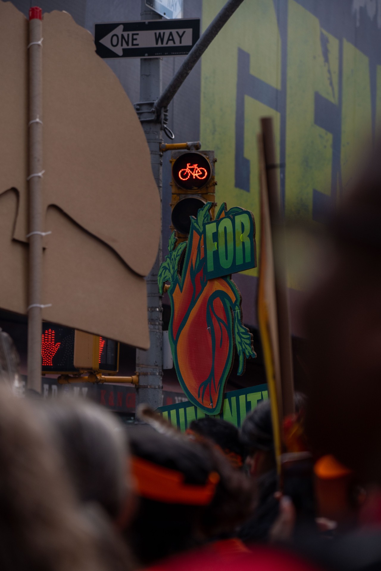 The shot of a sign being held high right below a traffic stop at climate change protests in NYC.