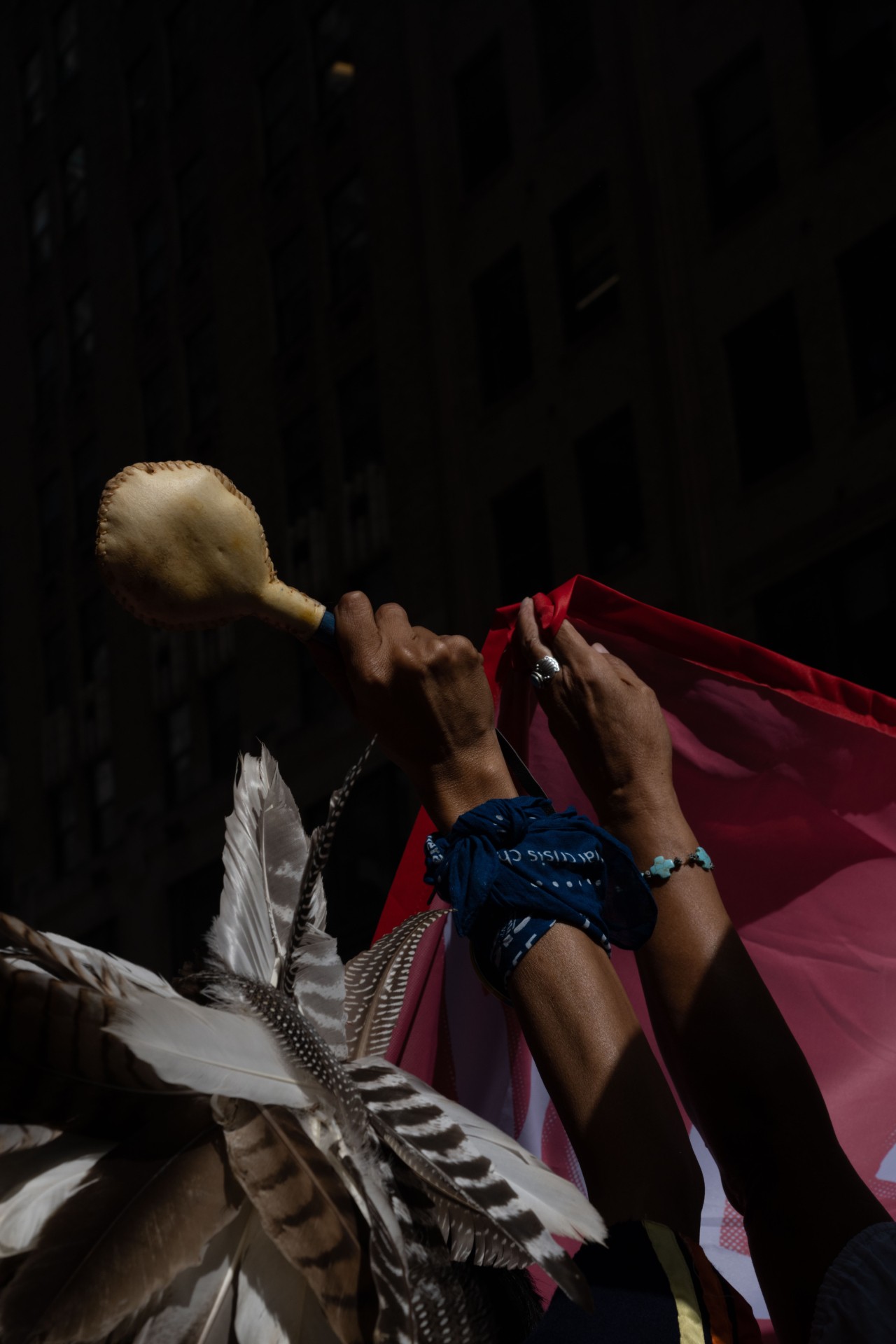 During climate change protests in NYC, indigenous protestors raise flags and artifacts to show representation.