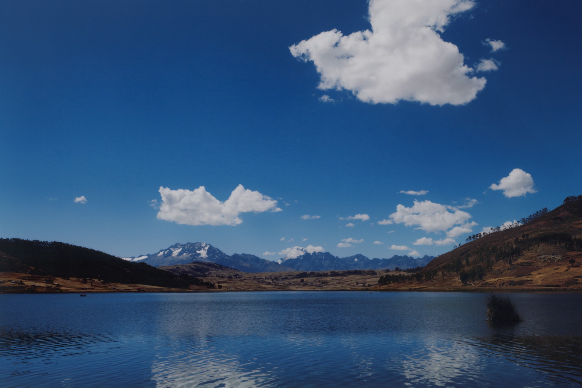 The water gleams and the sky is bright blue in the Sacred Valley