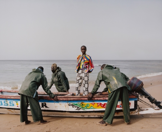 Model standing on a boat, photographed by Nadine Ijewere