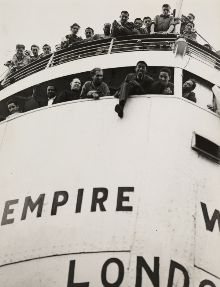 The 'Empire Windrush' docked at Tilbury with several people aboard.
