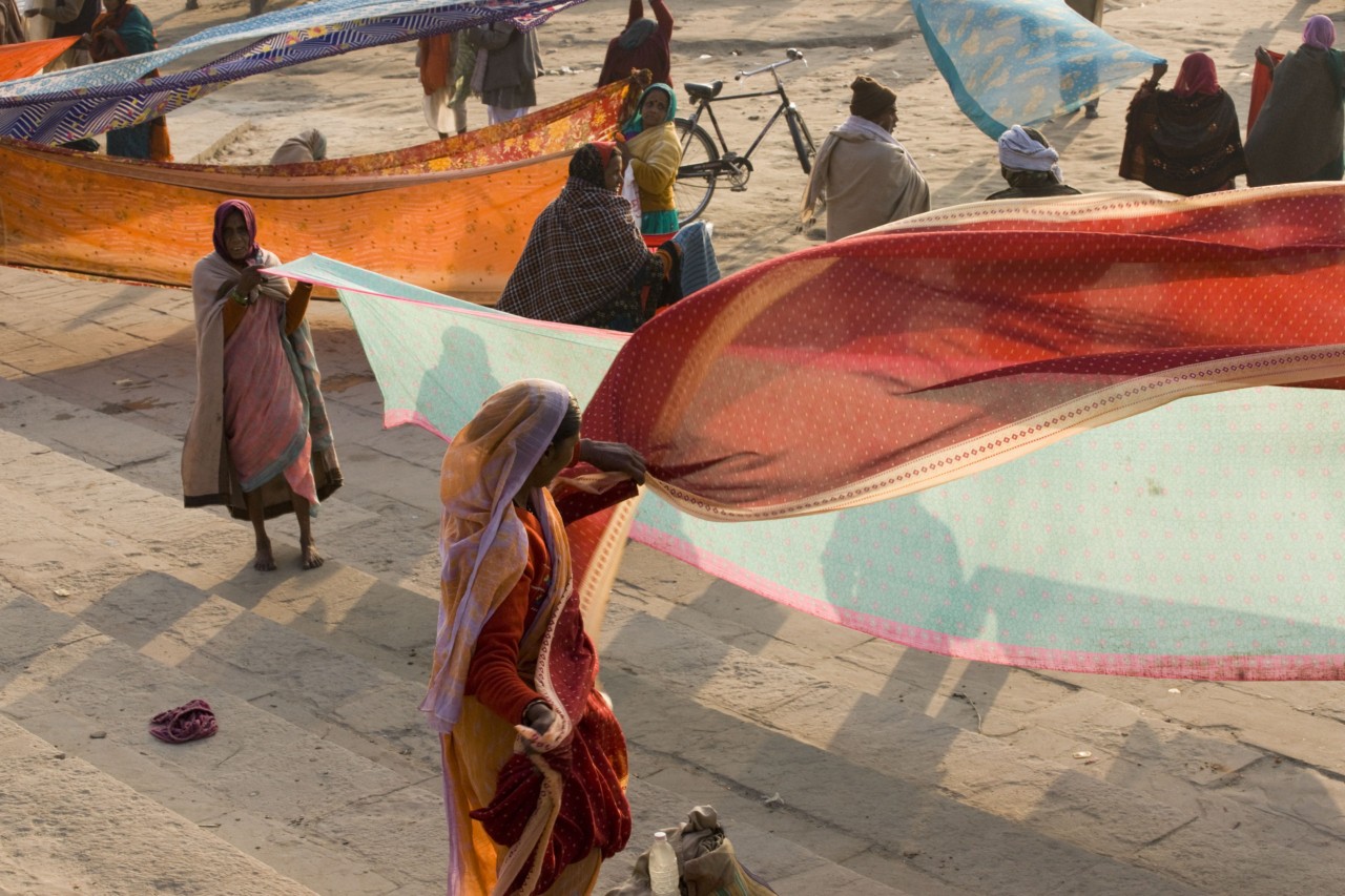 INDIA. 1. Uttar Pradesh. Varanasi. After a dip in the river Ganges, women pilgrims dry their saris.