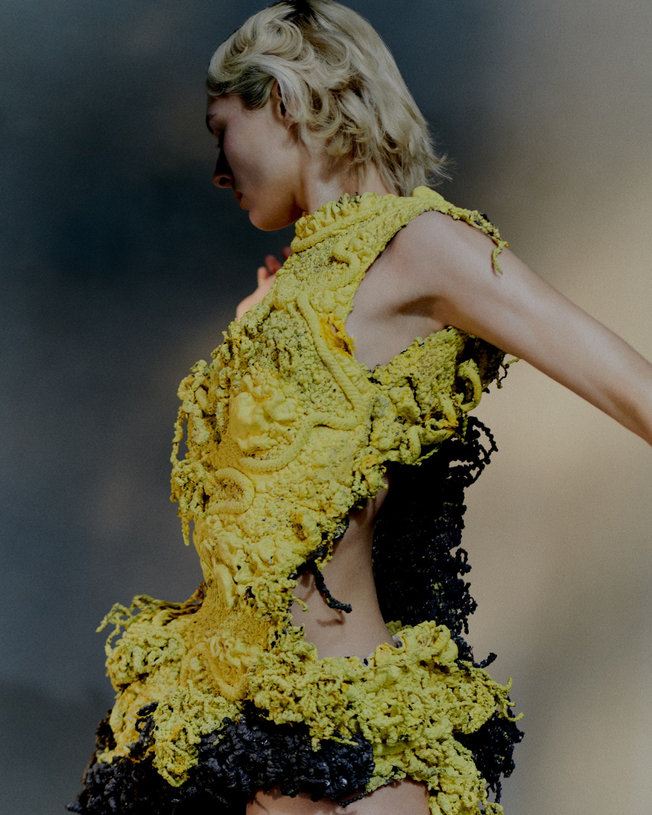A model wears a dress made from yellow and biocouture.