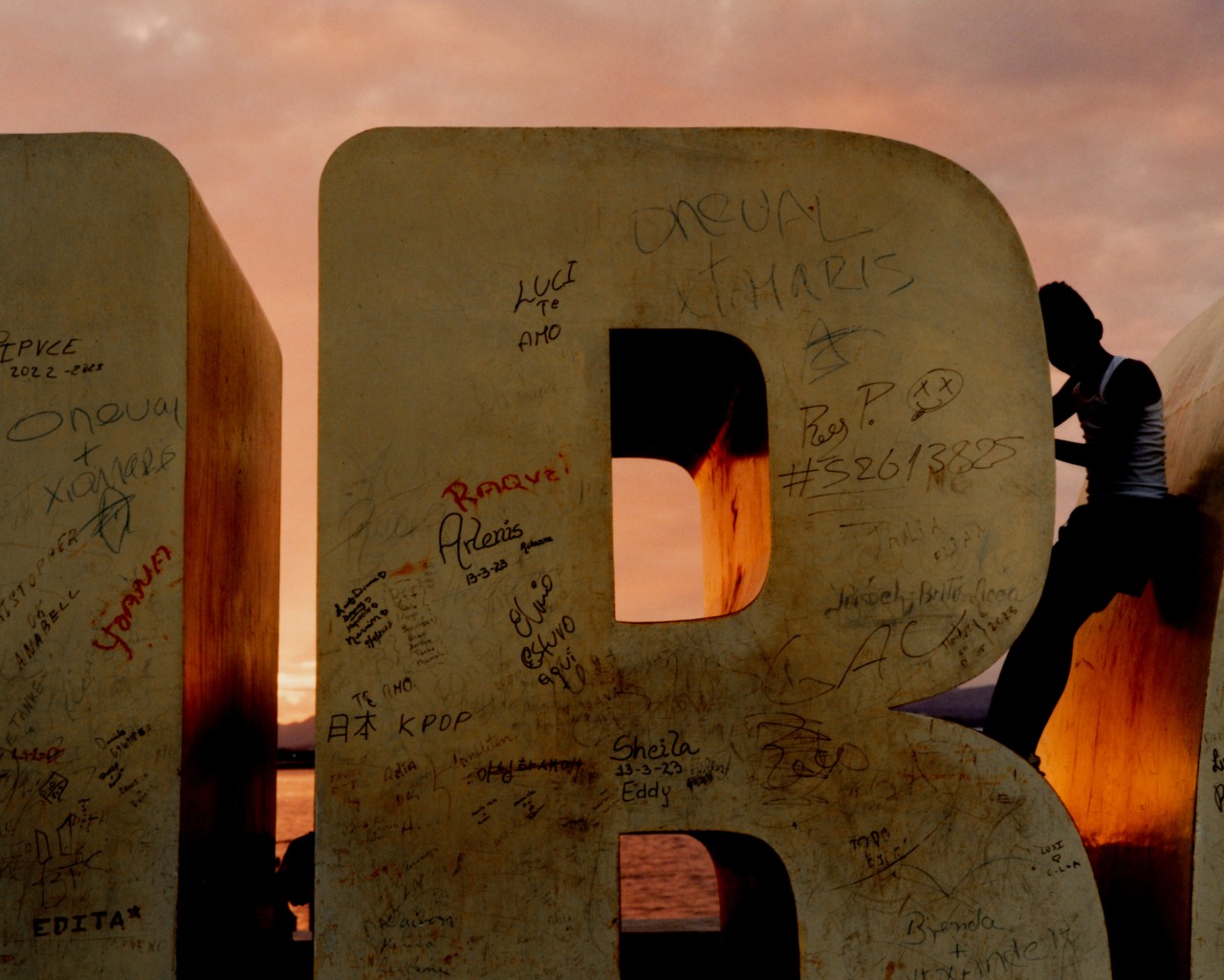 A child holds onto a large block letter.