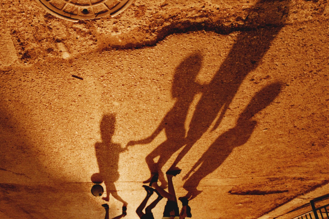 The shadows of children playing together.