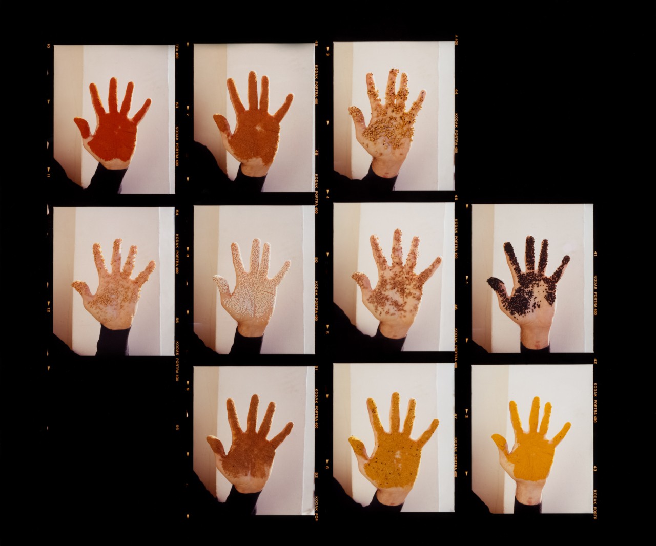 A collage of hands covered in paint.