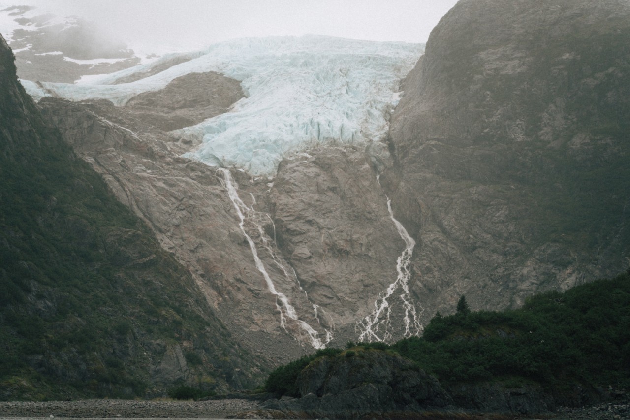 Melted ice water runs down a mountain slope.