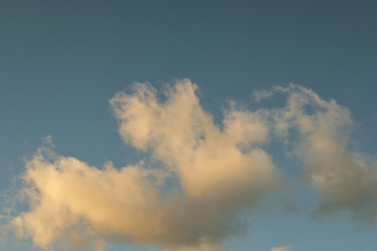 Clouds sit high in a blue sky.