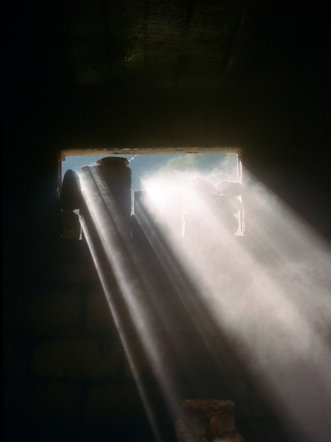 Light shines though a small rectangular window.