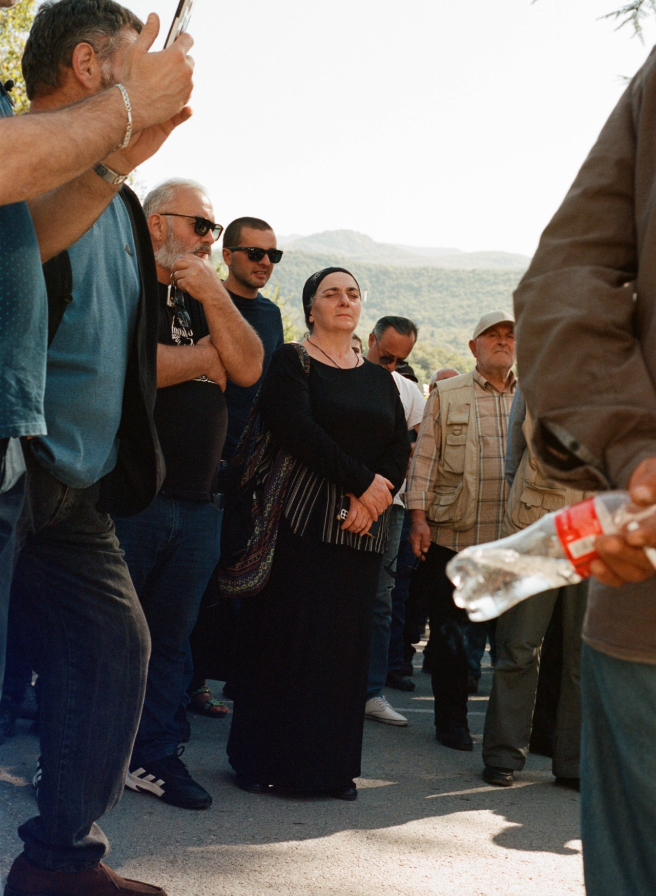 People stand side by side at a protest in Georgia.
