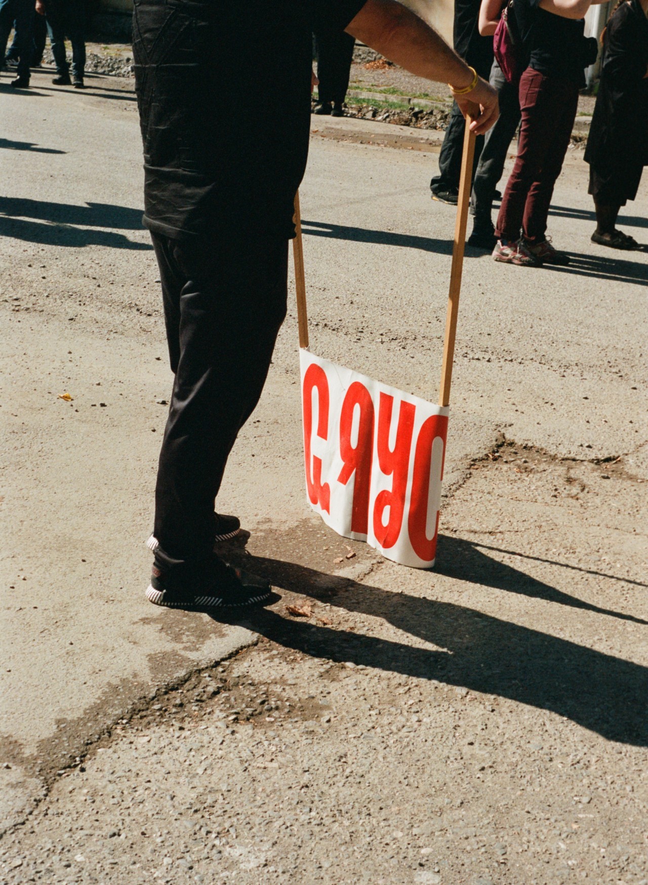 A person holds a protest sign.