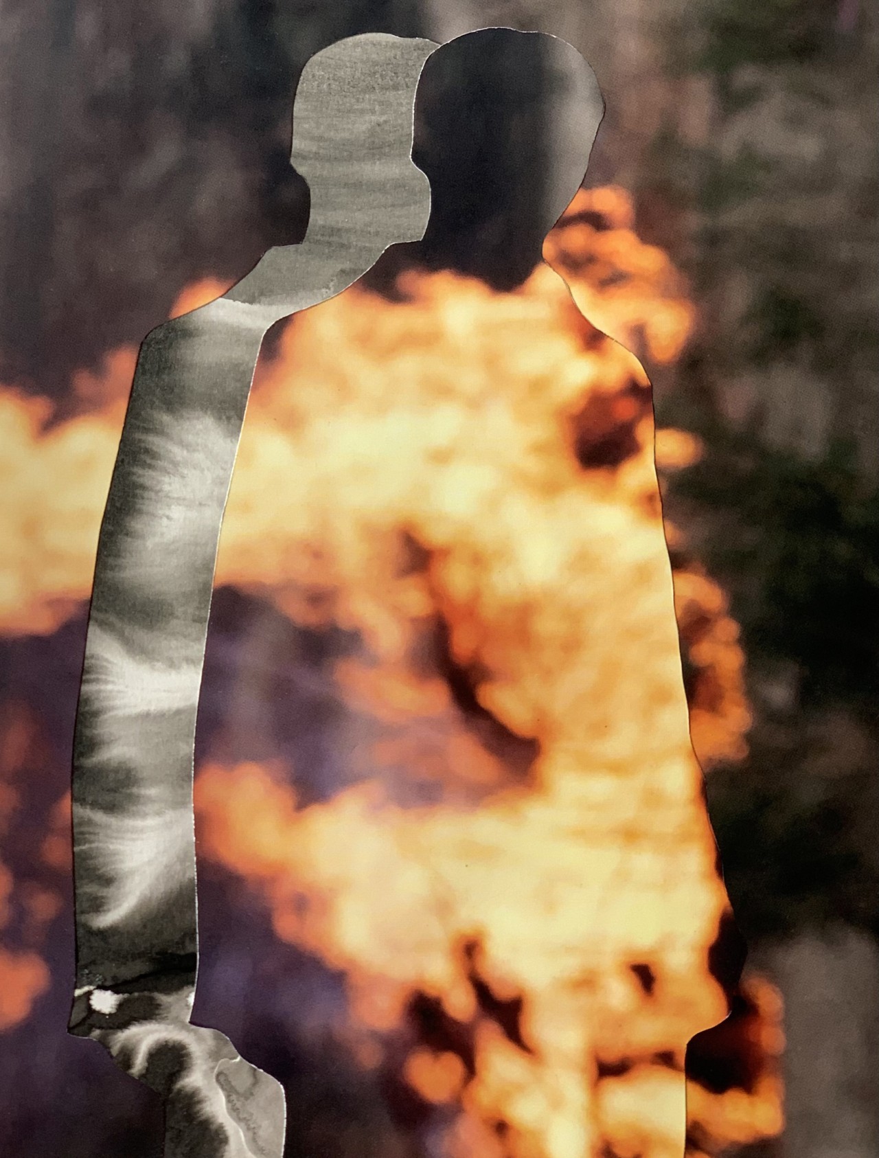 A double exposure shadowed figure is on fire.