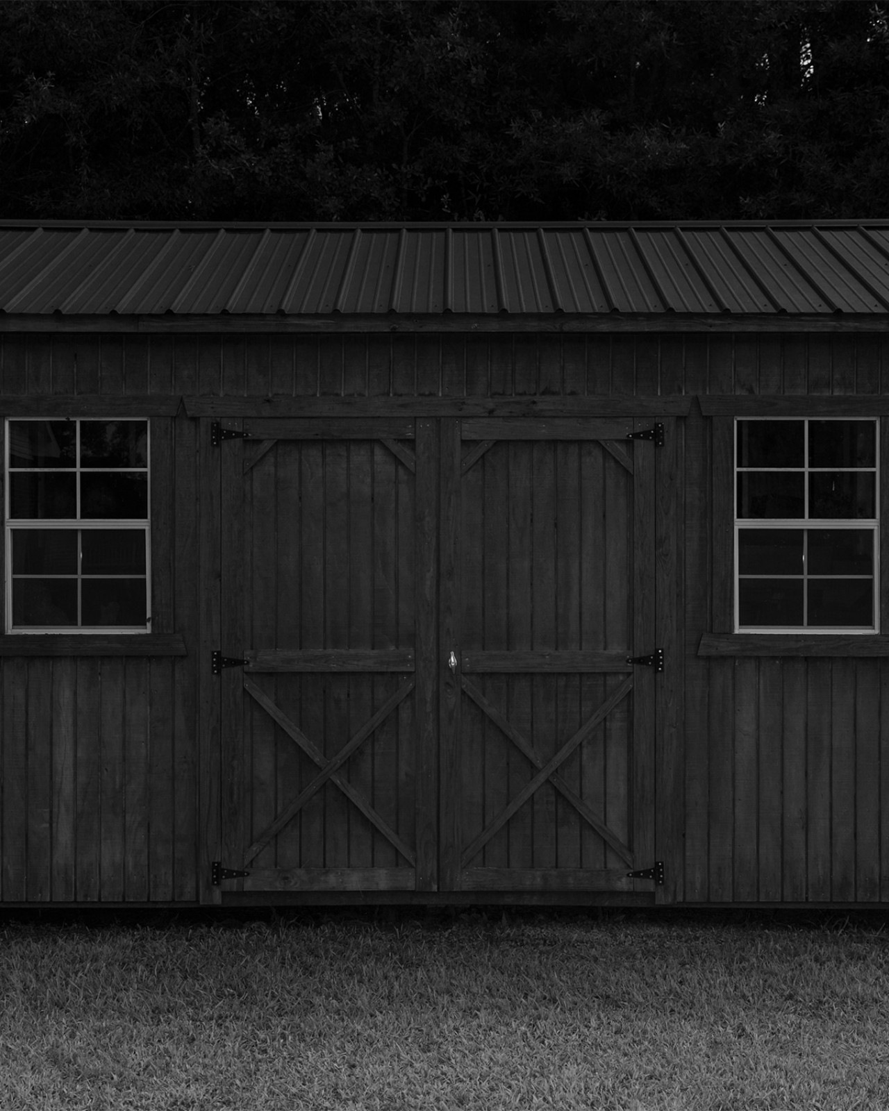A wooden cabin rests in dark lighting.