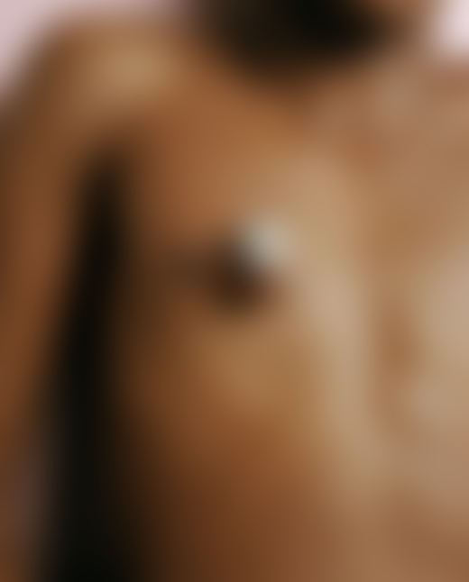 A tiny crab crawls along the chest of a human.