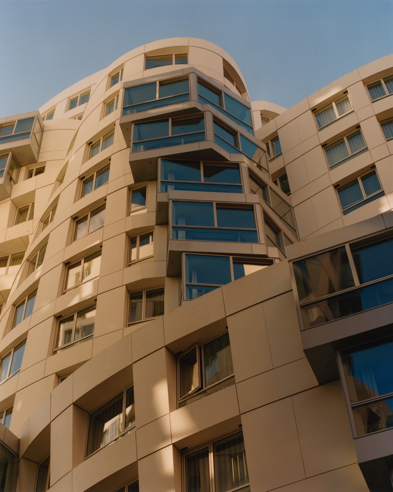 A stacked, twisted beige building.