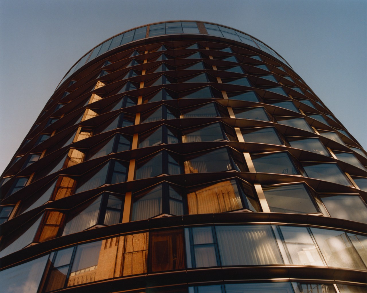 A cylindrical building with glass windows.