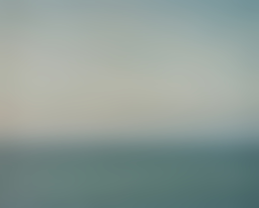 A cloudy sky sits above the vast ocean.