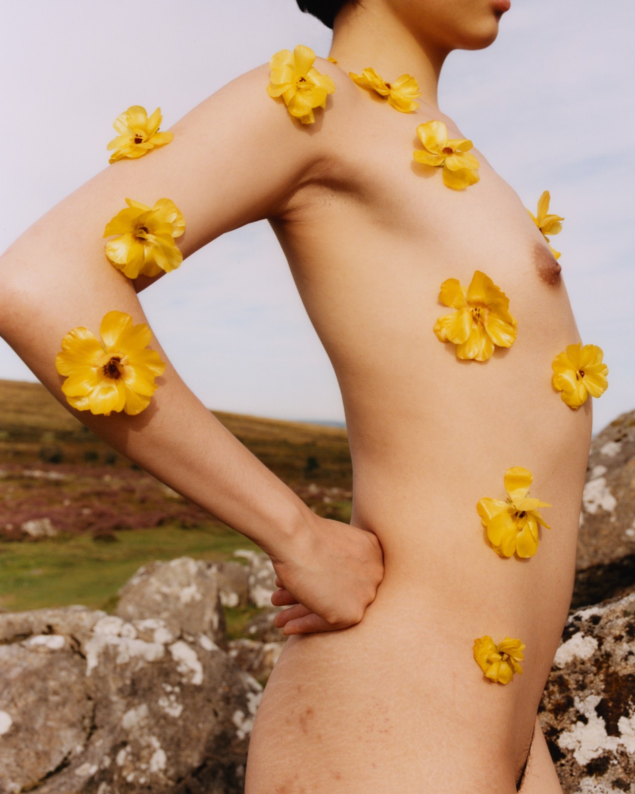 Yellow flowers stick to the body of a model.