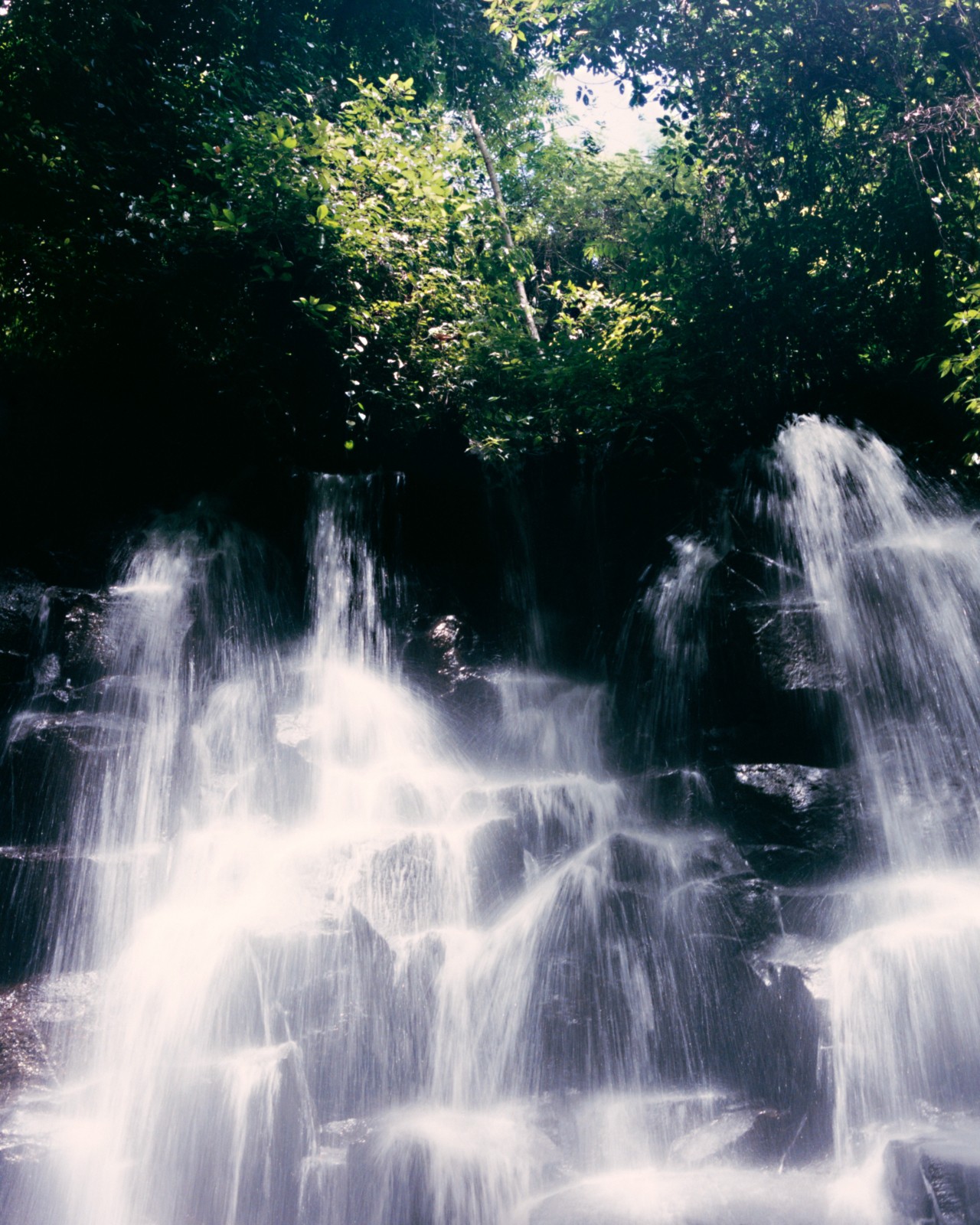 Water cascades over a stack of rocks.
