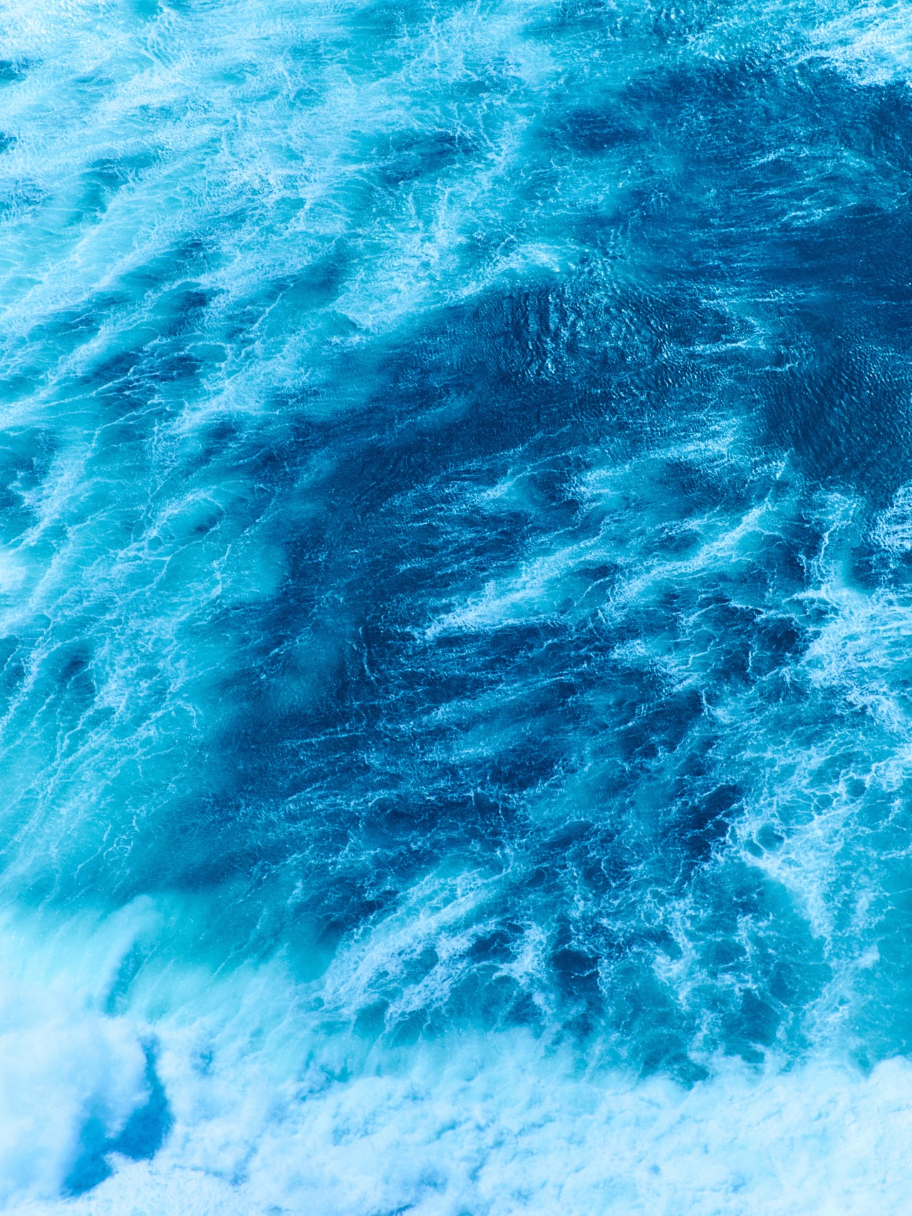 Waves crash together in the ocean.