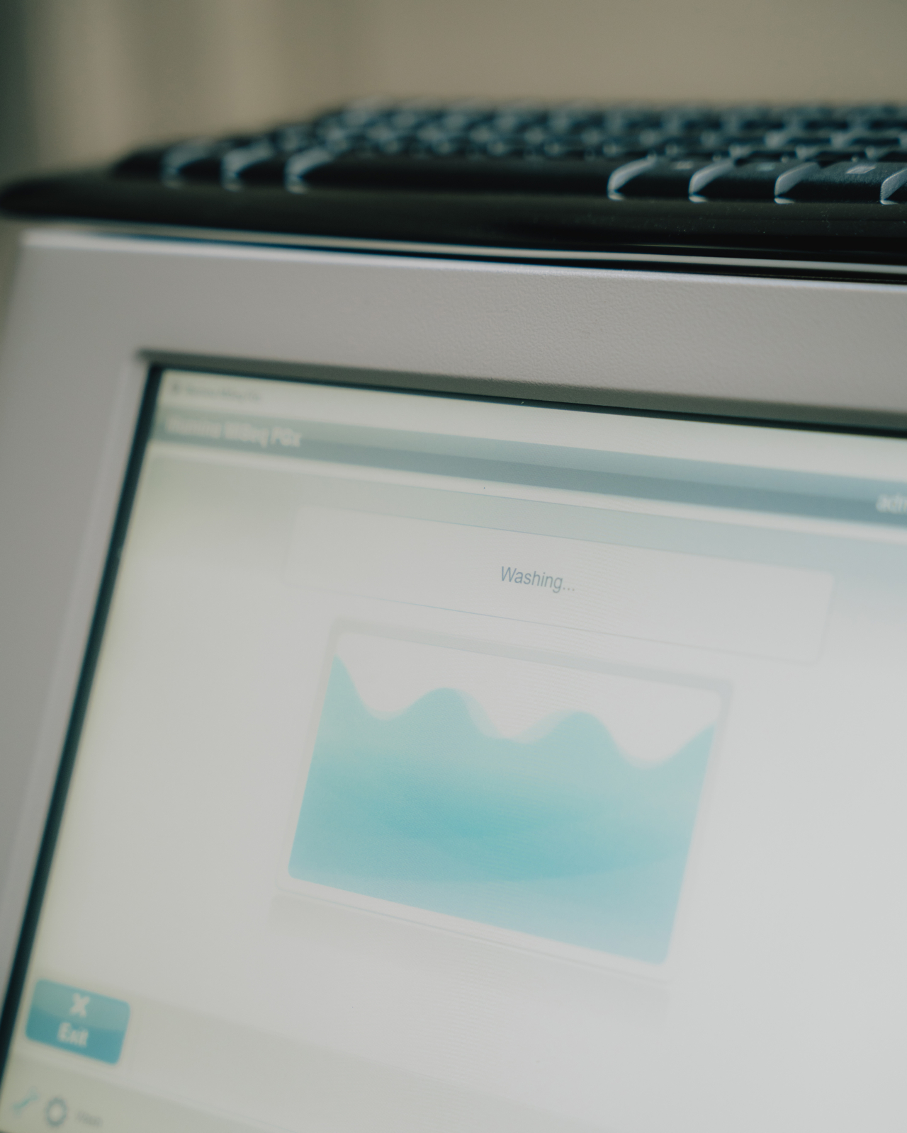 A computer monitor shows a blue and white graph with a caption that reads 