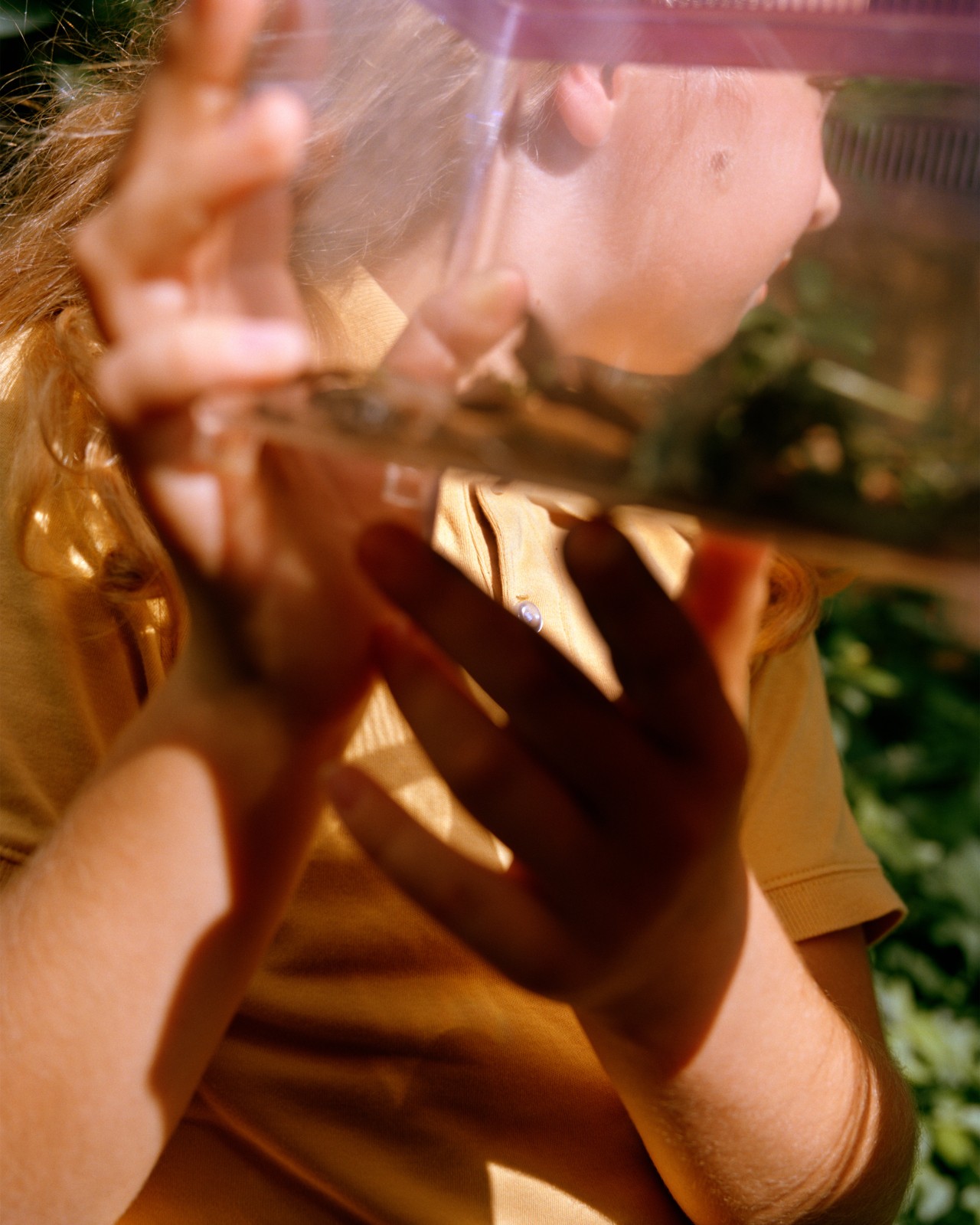 A child holds a plastic tank.