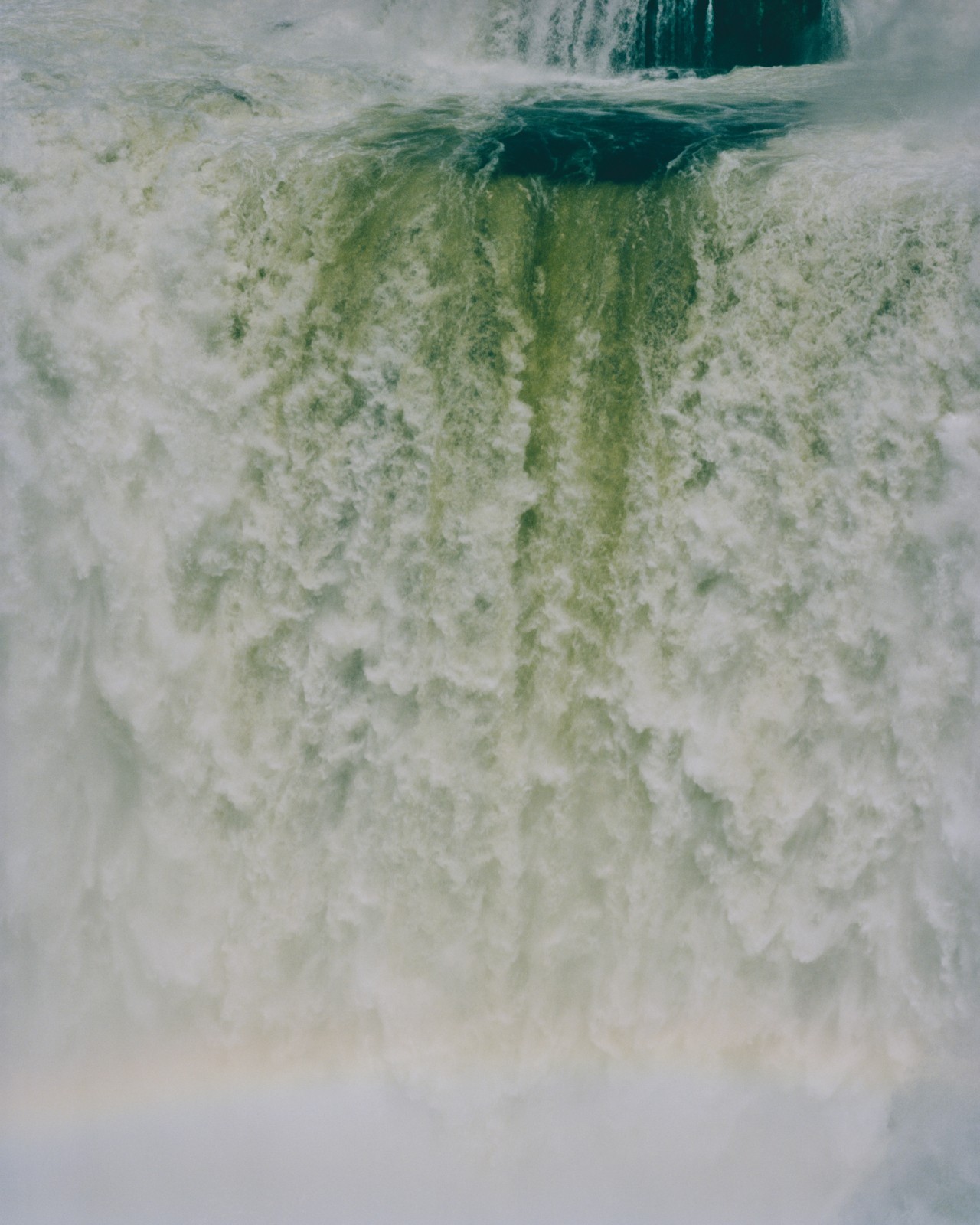 A gushing blue green waterfall.