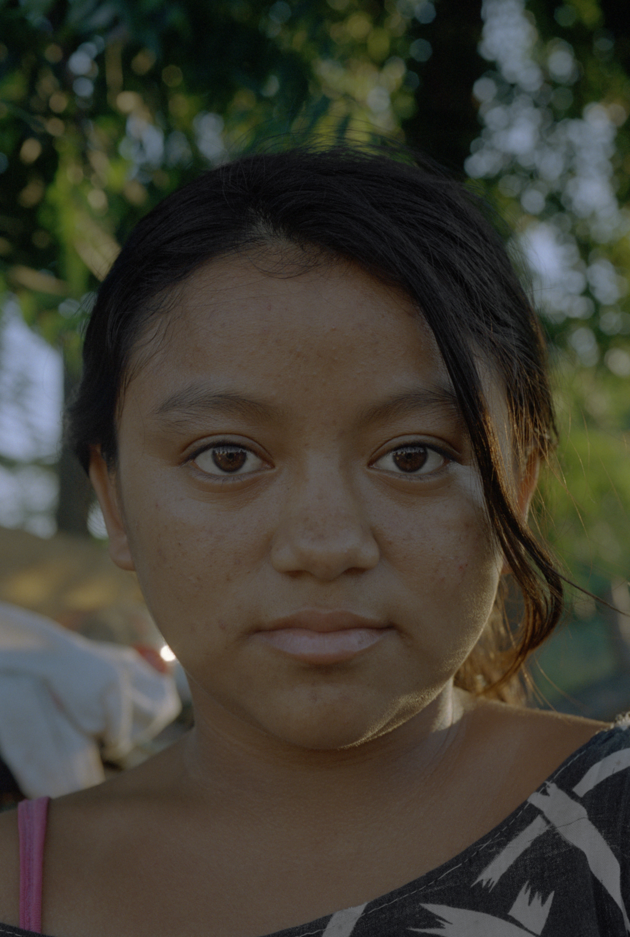 An Indigenous child looks directly into the camera.