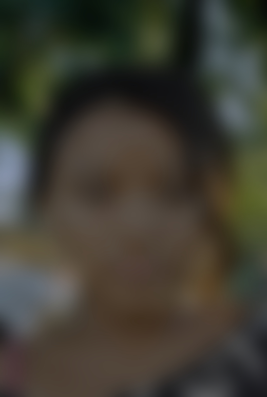 An Indigenous child looks directly into the camera.