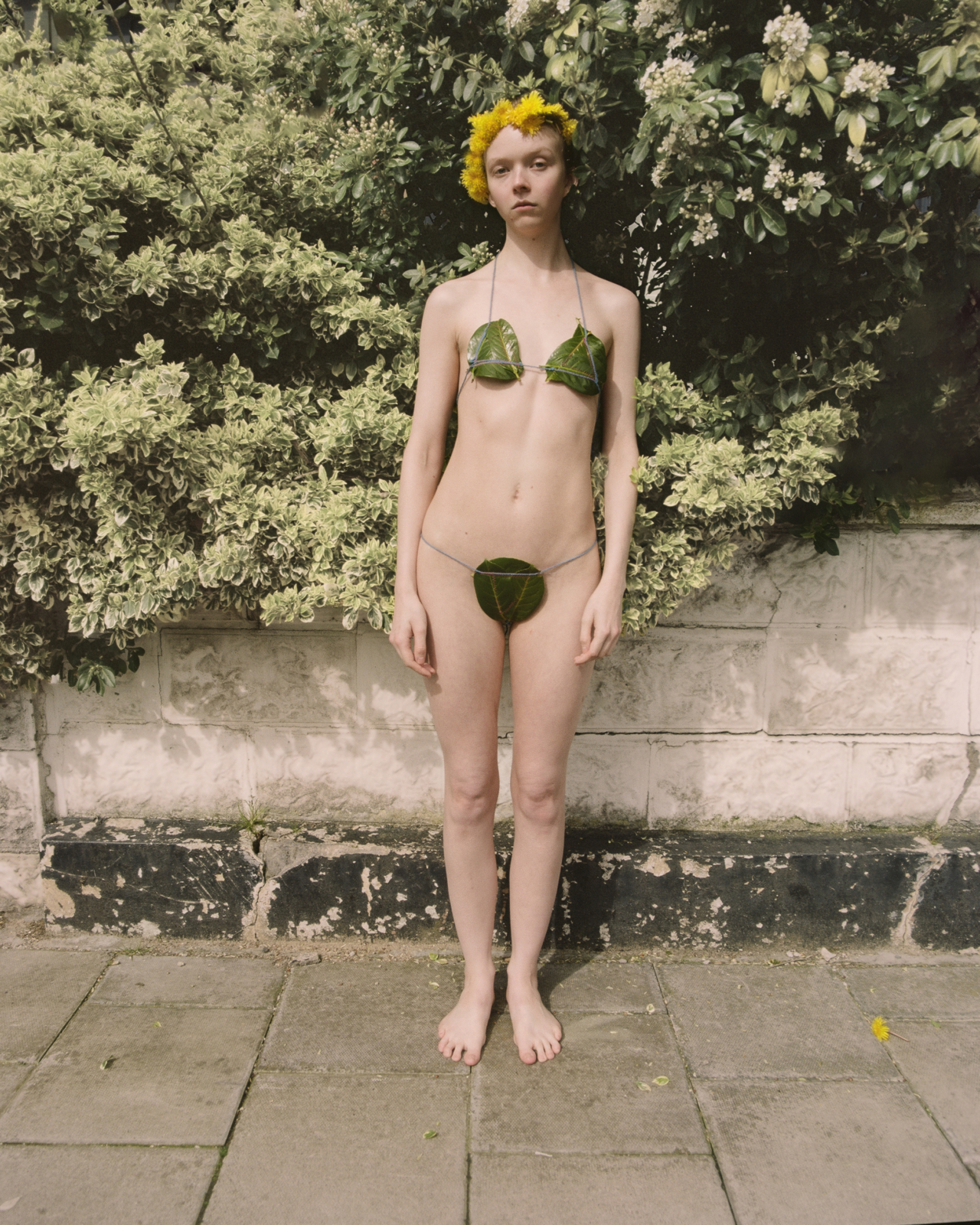 A model poses wearing a bikini made from leaves.
