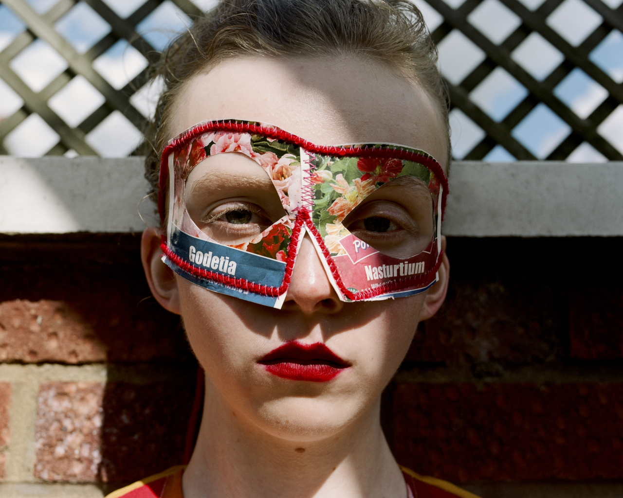 A model wears an eye mask with floral designs on it.