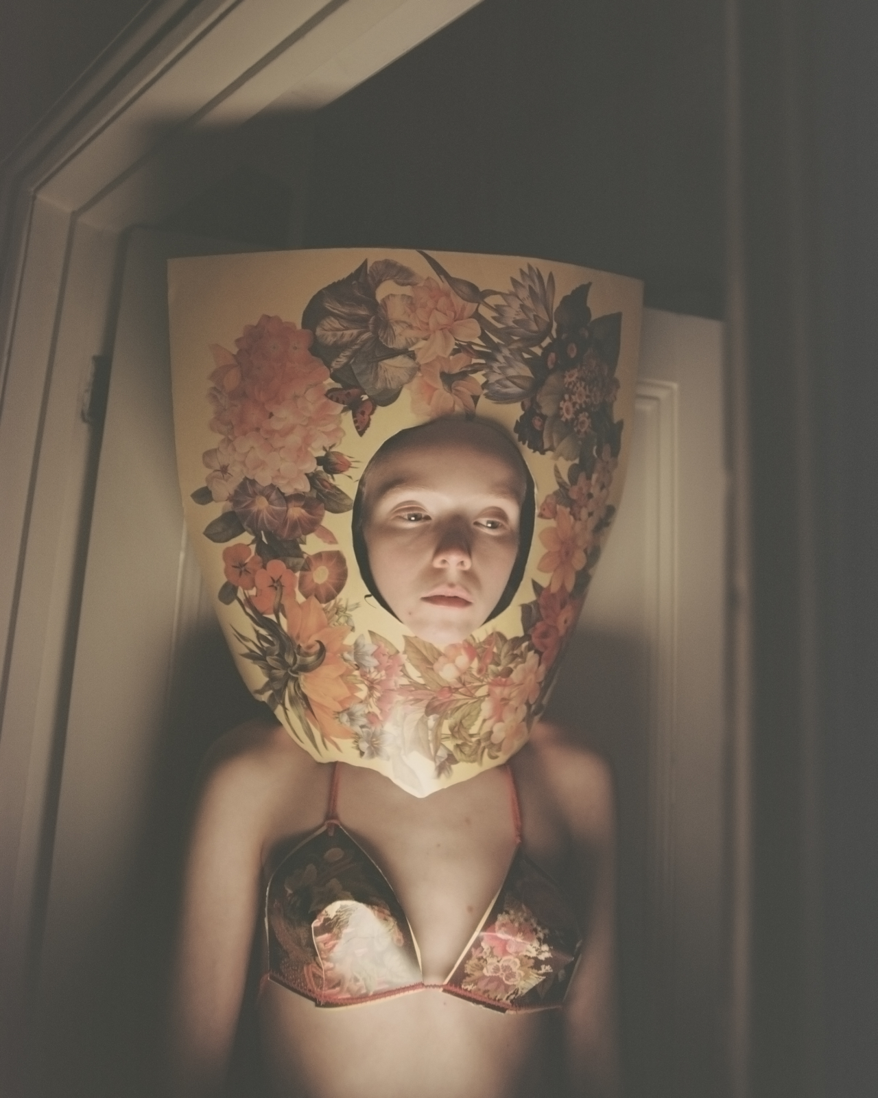 A model wears a bikini and head piece decorated with flower art.